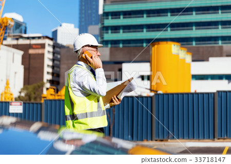 Engineer builder at construction site 33718147