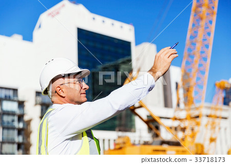 Engineer builder at construction site 33718173