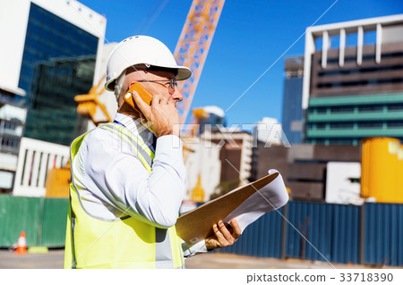 Engineer builder at construction site 33718390