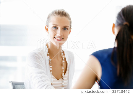 Two female colleagues in office 33718442