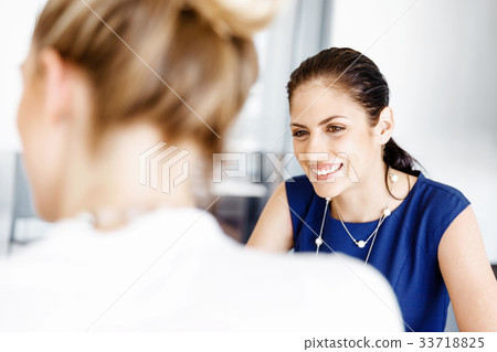 Two female colleagues in office 33718825
