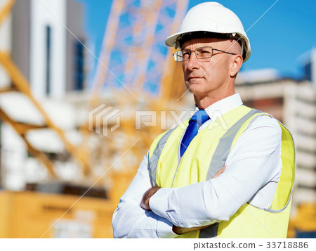 Engineer builder at construction site 33718886