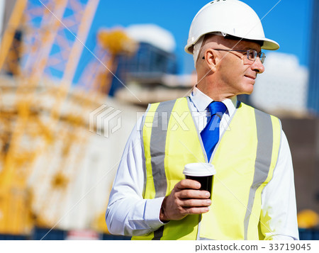 Engineer builder at construction site 33719045