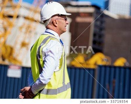 Engineer builder at construction site 33719354