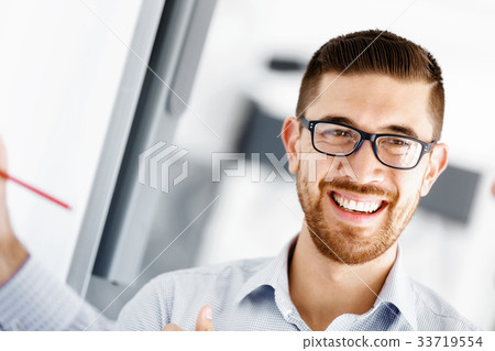 Handsome businessman in office Handsome businessman in office 33719554