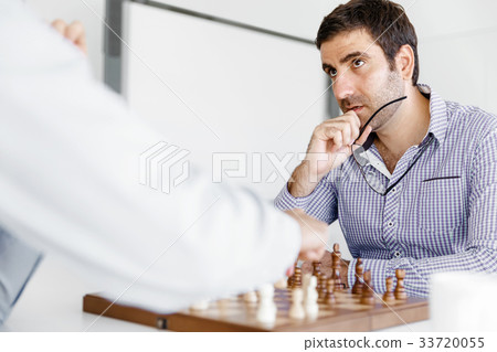 Portrait of two young man playing chess 33720055