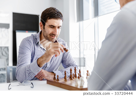Portrait of two young man playing chess Portrait of two young man playing chess 33720444