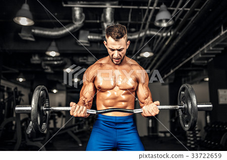 Bodybuilder sportsman working out with a barbell Bodybuilder sportsman working out with a barbell 33722659