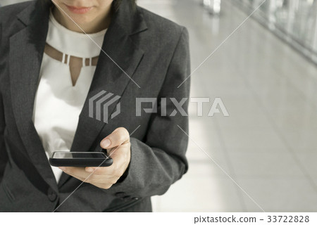 Businesswoman using smart phone Businesswoman using smart phone 33722828