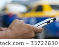 using smart phone at sideroad 33722830