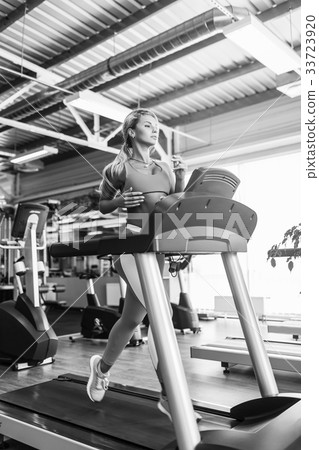 Young fitness woman doing cardio exercises at the 33723920