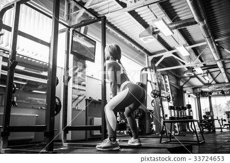 Young blonde sexy girl doing squat. 33724653
