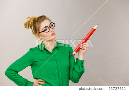 Woman confused thinking, big pencil in hand 33727811