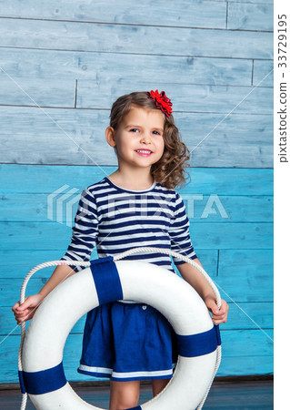 child standing and holding a lifebuoy child standing and holding a lifebuoy 33729195
