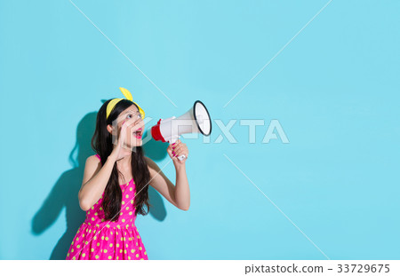 young smiling woman holding loudspeaker device 33729675