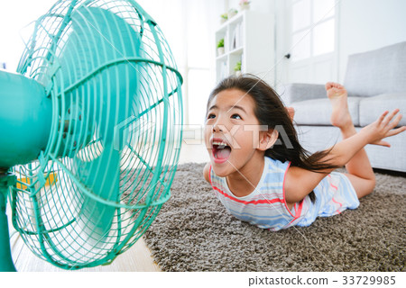 sweet little children lying down on living room 33729985