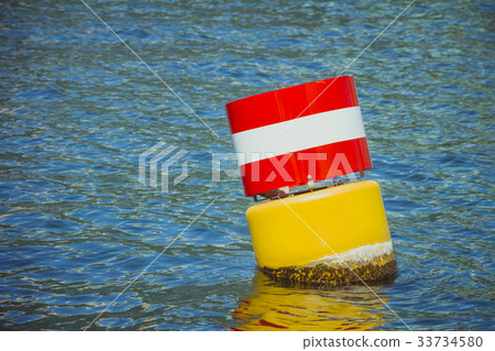 Yellow red and white navigational floating buoy Yellow red and white navigational floating buoy 33734580