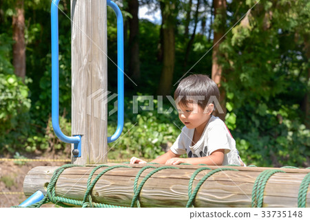 A boy playing in a park A boy playing in a park 33735148