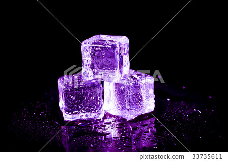 Purple ice cubes on a black table. 33735611