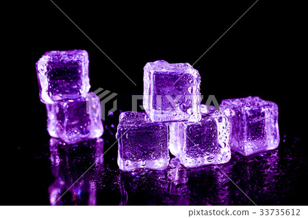 Purple ice cubes on a black table. 33735612