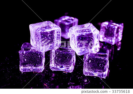 Purple ice cubes on a black table. Purple ice cubes on a black table. 33735618
