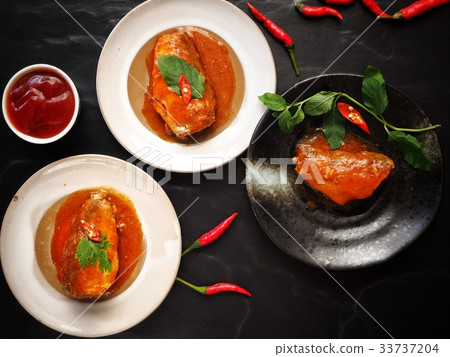 Canned fish on black background Canned fish on black background 33737204