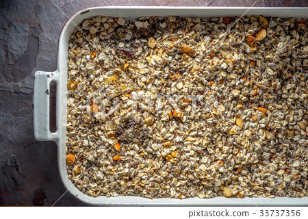 Granola mix in baking dish close-up Granola mix in baking dish close-up 33737356