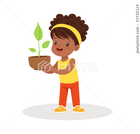 Sweet little girl standing and holding a plant in Sweet little girl standing and holding a plant in 33738124