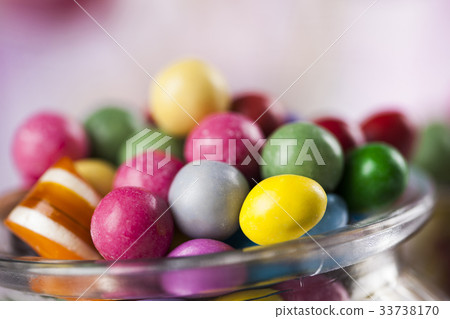 Assorted candies including lollipops, gum balls Assorted candies including lollipops, gum balls 33738170