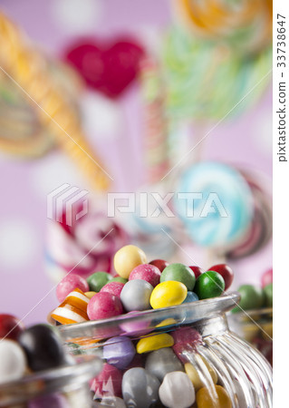 Assorted candies including lollipops, gum balls Assorted candies including lollipops, gum balls 33738647
