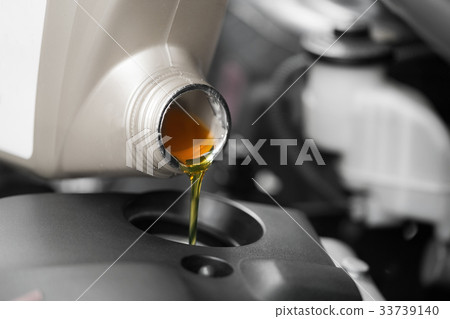 Close up, Pouring motor oil to car engine. 33739140