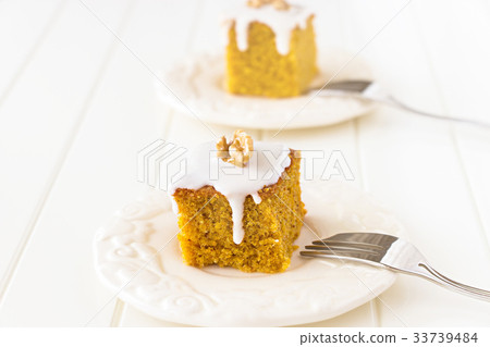 Two Pieces carrot cake with nut and icing cream 33739484