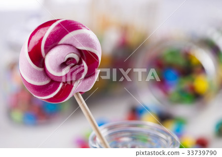 Colorful candies in jars on table on gum balls Colorful candies in jars on table on gum balls 33739790