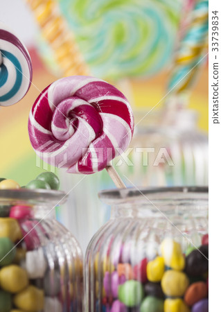 Colorful candies in jars on table on gum balls Colorful candies in jars on table on gum balls 33739834