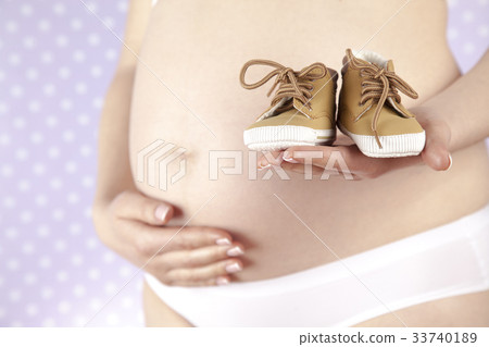 Pregnancy concept, female hands shoes Pregnancy concept, female hands shoes 33740189