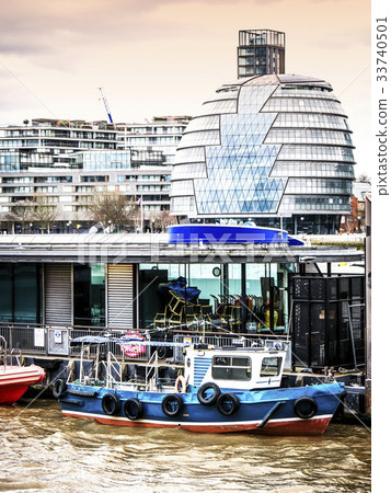 Old boat moored on the Thames and the London City 33740501