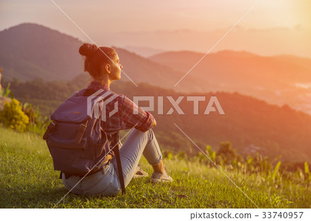 Hipster young girl with backpack enjoying sunset  33740957
