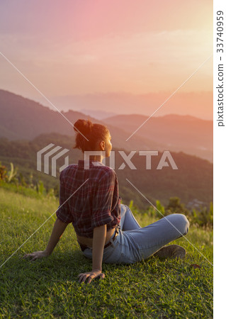 Hipster young girl with backpack enjoying sunset  33740959
