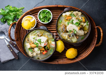 Seafood fish soup in clay bowls served with lemon Seafood fish soup in clay bowls served with lemon 33741030