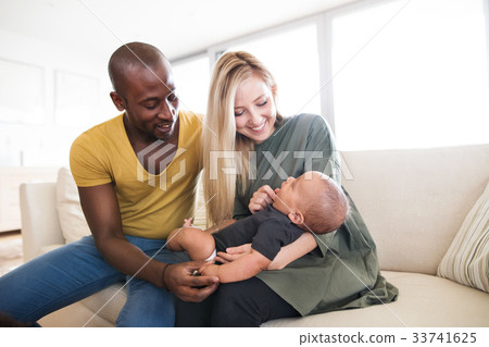 Young interracial family with little baby son at 33741625