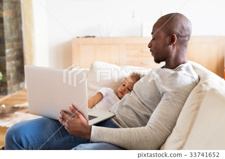 Afro-american father with little daughter at home 33741652