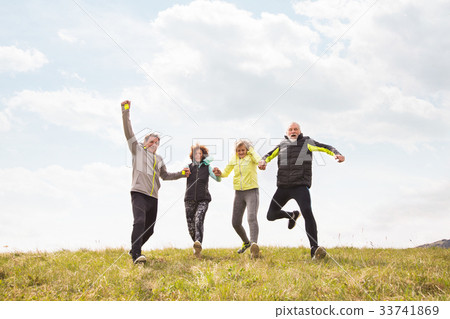 Group of senior runners outdoors, resting, holding Group of senior runners outdoors, resting, holding 33741869