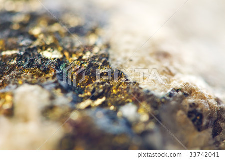 Golden background from natural mineral. Macro 33742041