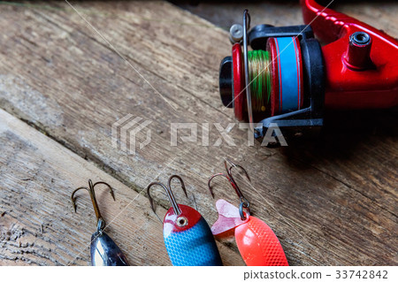 fishing tackle on a wooden surface fishing tackle on a wooden surface 33742842