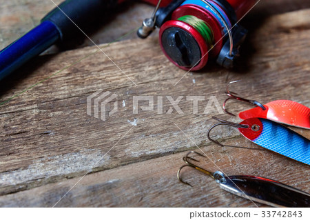 fishing tackle on a wooden surface 33742843