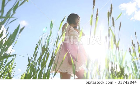 Girl sexy in a dress in a field of green grass Girl sexy in a dress in a field of green grass 33742844