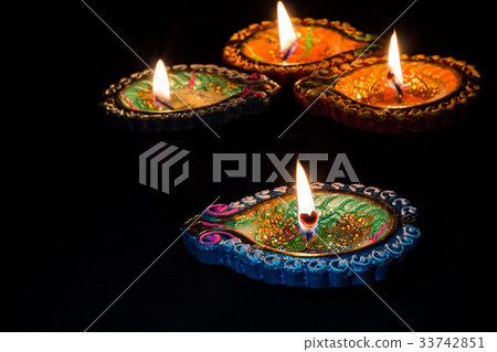 Four burning candles indian style for Diwali 33742851
