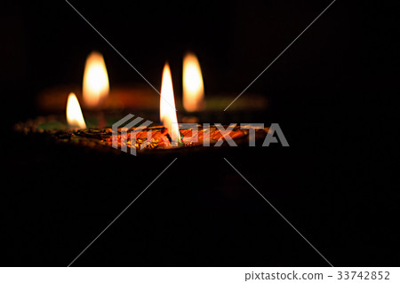 Four burning candles indian style for Diwali 33742852