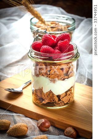 Muesli with yogurt and raspberries. Muesli with yogurt and raspberries. 33744951