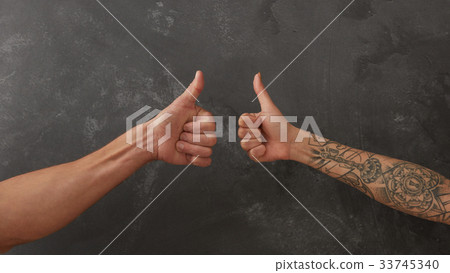 Hand of man and female hand with tattoo 33745340